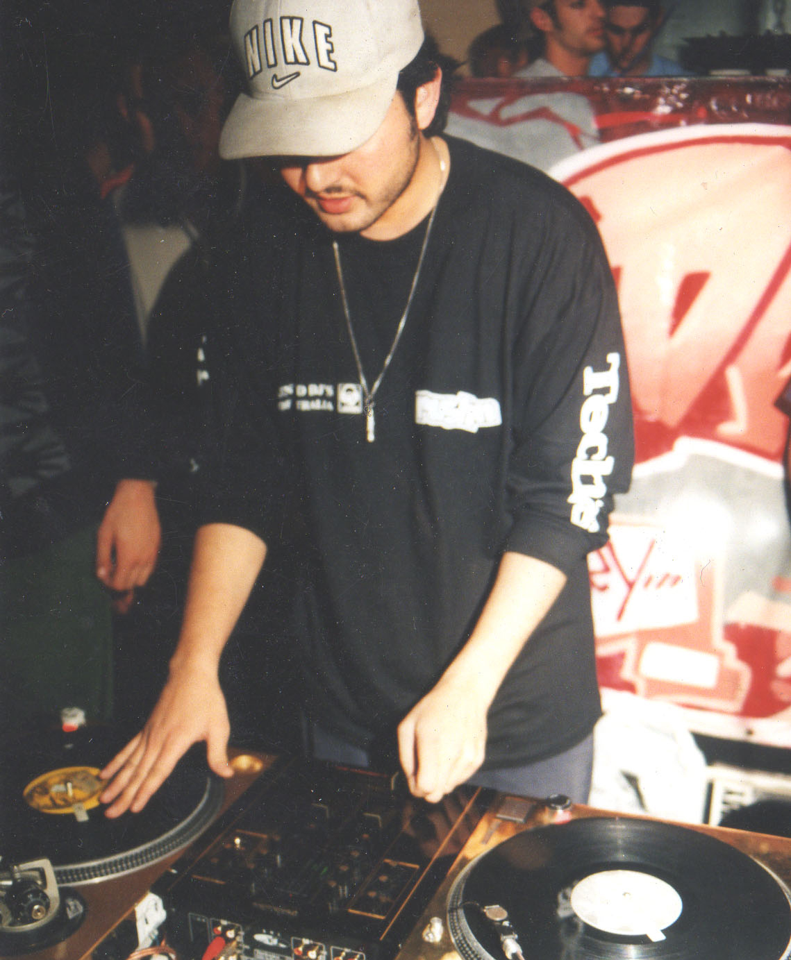 DJ KC behind a pair of Technics turntables