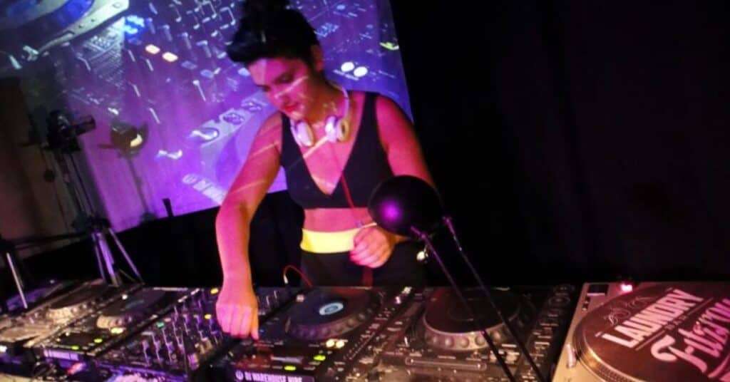 DJ student mixing on CDJs and turntables